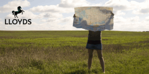 Woman holding a map in a field